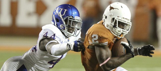 Kansas linebacker Malcolm Walker can't hold back Texas running back Fozzy Whittaker during a run in the fourth quarter on Saturday, Oct. 29, 2011 at Darrell K Royal-Texas Memorial Stadium.