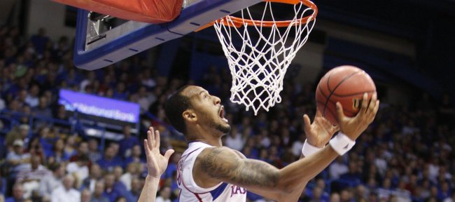 Kansas guard Travis Releford is fouled as he goes up for a reverse layup against Towson during the first half on Friday, Nov. 11, 2011 at Allen Fieldhouse.