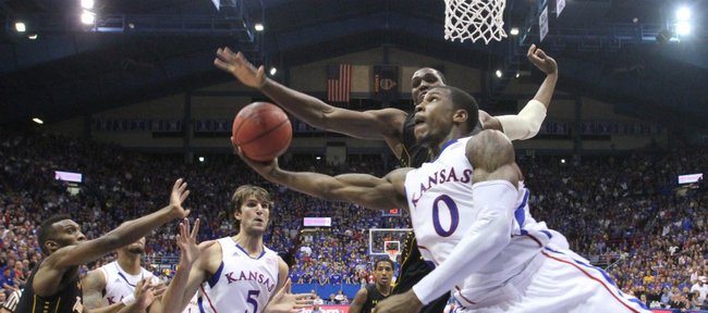 Kansas forward Thomas Robinson tries to hook a shot under the bucket amidst the Towson defense during the second half on Friday, Nov. 11, 2011 at Allen Fieldhouse.