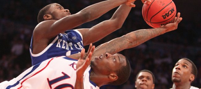 Kansas guard Tyshawn Taylor is smothered by Kentucky forward Michael Kidd-Gilchrist during the second half on Tuesday, Nov. 15, 2011 at Madison Square Garden in New York.