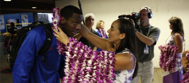 Kansas guard Tyshawn Taylor leans forward to receive a lei as a welcoming gesture upon the Jayhawks' arrival at the Kahului Airport on Friday, Nov. 18, 2011 in Maui.