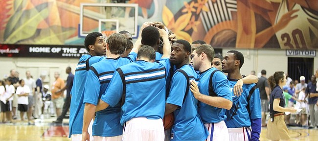 The Kansas Jayhawks come together in a huddle wearing special warmups for the Maui Invitational before tipping off against Georgetown on Monday, Nov. 21, 2011 at the Lahaina Civic Center.