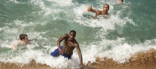 Kansas guards Tyshawn Taylor, left of center, Travis Releford and team video coordinator Doug Compton Jr., catch a wave during some free time before practice on Sunday, Nov. 20, 2011 on Kaanapali Beach in Lahaina. The Jayhawks take on Georgetown Monday night during the Maui Invitational.