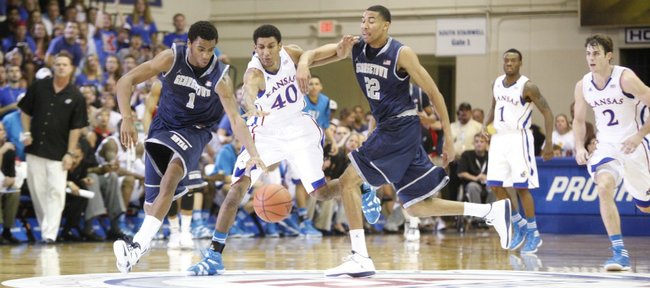 Kansas forward Kevin Young splits Georgetown defenders Hollis Thompson (1) and Otto Porter (22) after a steal during the first half Monday, Nov. 21, 2011 at the Lahaina Civic Center.