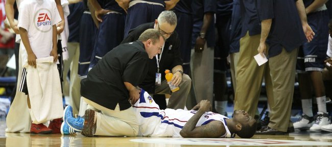 Kansas guard Tyshawn Taylor winces in pain as he lies on the ground with cramps during the second half on Monday, Nov. 21, 2011 at the Lahaina Civic Center.
