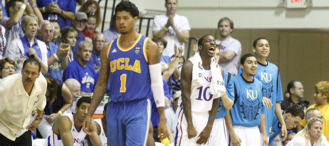 Kansas guard Tyshawn Taylor (10) celebrates on the bench next to teammates Niko Roberts and Merv Lindsay as the Jayhawks go on a run against UCLA during the first half Tuesday, Nov. 22, 2011 at the Lahaina Civic Center.