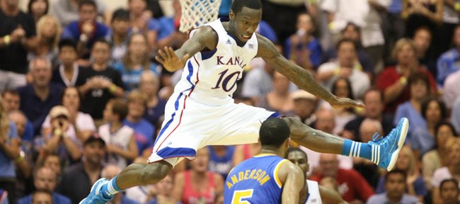 Kansas guard Tyshawn Taylor gets airborne as he defends against a pass from UCLA guard Jerime Anderson during the second half Tuesday, Nov. 22, 2011 at the Lahaina Civic Center.