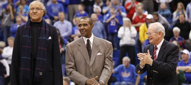 Former Kansas players on the 1966 team Walt Wesley, left, and JoJo White stand with then head coach Ted Owens as they are honored at halftime of the South Florida game on Saturday, Dec. 3, 2011 at Allen Fieldhouse.