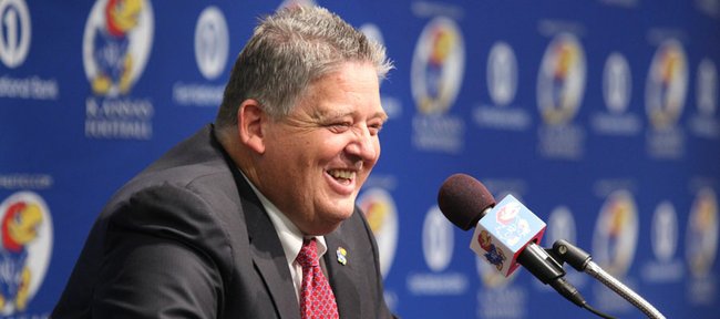 Charlie Weis laughs at the podium as he addresses media members during a news conference in which Weis was announced as the new football coach for KU on Friday, Dec. 9, 2011 at the Anderson Family Football Complex.