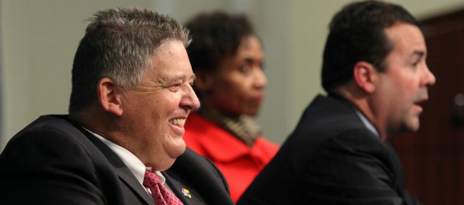 Charlie Weis laughs as he sits at a table with Kansas University athletic director Sheahon Zenger and Chancellor Bernadette Gray-Little during a news conference in which Weis was announced as the new head football coach Friday, Dec. 9, 2011 at the Anderson Family Football Complex.