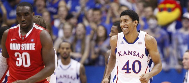 Kansas forward Kevin Young flashes a smile after taking a charge against an Ohio State player during the first half Saturday, Dec. 10, 2011 at Allen Fieldhouse.