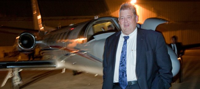 The hiring of Charlie Weis, as KU's new football coach provided staff photographers Nick Krug and myself three different photo events to cover on his arrival to Lawrence. The trickiest for me was a night time coverage of Weis's arrival at the Lawrence airport. Getting correct flash exposures and photographing through glass were two problems I dealt with to capture the new coach.