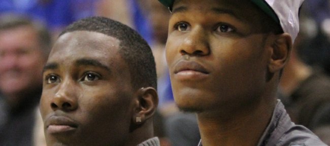 Kansas freshmen Jamari Traylor, left, and Ben McLemore  watch the Late Night in the Phog festivities from the bench on Friday, Oct. 14, 2011 at Allen Fieldhouse.