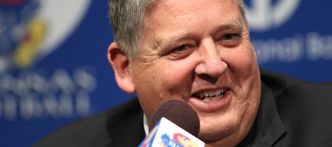 Charlie Weis laughs with media members during a news conference on Friday.