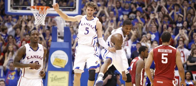 Kansas big men Jeff Withey (5) and Thomas Robinson get airborne as they celebrate a Jayhawk run against Oklahoma during the second half on Wednesday, February 1, 2012 at Allen Fieldhouse. At left is KU guard Tyshawn Taylor.