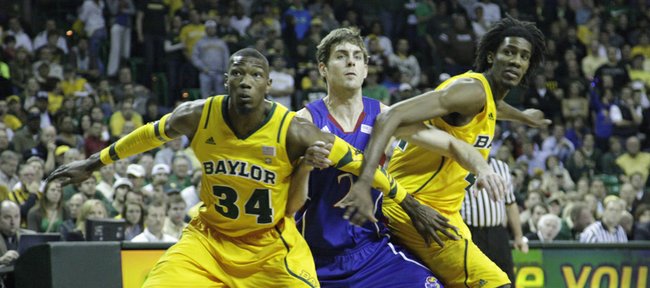 Connor Teahan (2) gets blocked by Baylor's Cory Jefferson (34) and Anthony Jones (41) in the first half of the Jayhawks' game against the Bears.
