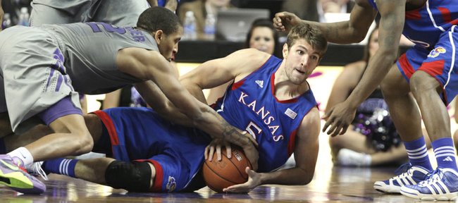 Kansas center Jeff Withey gets on the floor for a loose ball with Kansas State forward Rodney McGruder during the second half on Monday, Feb. 13, 2012 at Bramlage Coliseum. At right is KU guard Elijah Johnson.