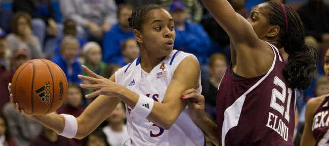 In this file photo from Jan. 21, 2012, Kansas University guard Angel Goodrich, left, looks to pass to a teammate as she hangs in the air. Goodrich became the KU single-season assists leader with her 208th assist vs. Texas Tech on Tuesday, Feb. 21, 2012 in Lubbock, Texas.