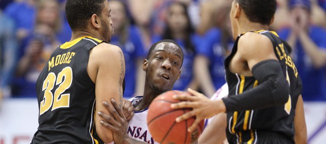 Kansas guard Tyshawn Taylor fights through a pick by Missouri forward Steve Moore as he defends MU guard Phil Pressey during the first half on Saturday, Feb. 25, 2012 at Allen Fieldhouse.