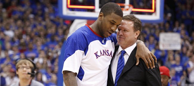 Kansas forward Thomas Robinson is hugged by head coach Bill Self as he is recognized before the fieldhouse during the senior speeches.