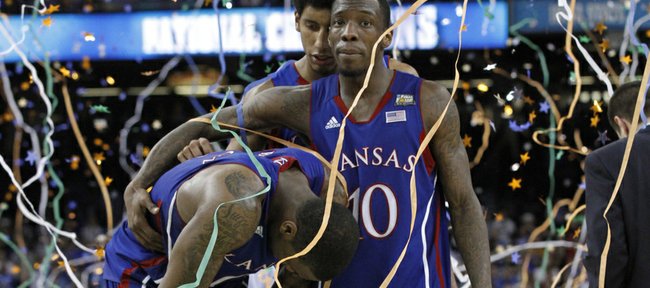 Thomas Robinson, left, is consoled by Tyshawn Taylor, left and Kevin Young, background,after KU's loss to Kentucky in the championship game Monday, April 2, 2012.
