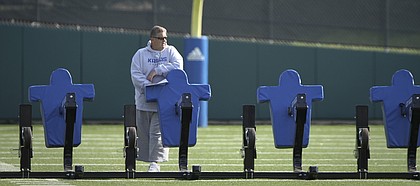 Kansas head coach Charlie Weis watches over practice from across the field on Tuesday, April 10, 2012.