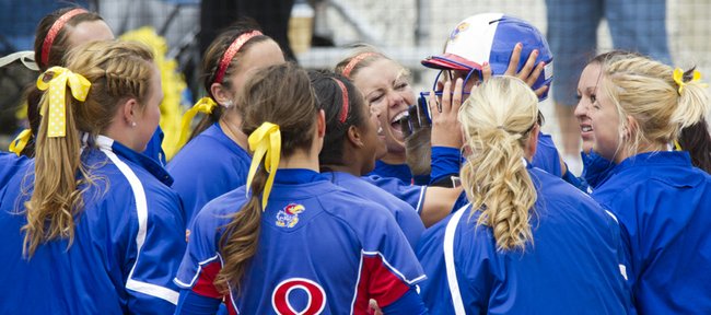 Kansas players gather at home plate to celebrate Maddie Stein's two-run home run during their game against Iowa State on Sunday, April 22, 2012 at Arrocha Ballpark.