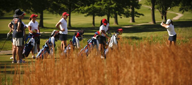 Members of the Kansas University women’s golf team wait to tee off during a practice round for the Big 12 Championships on Thursday, April 26, 2012, at Lawrence Country Club. 