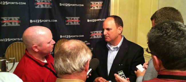Oklahoma athletic director Joe Castiglione talks to reporters at the Big 12 conference's annual spring meetings on Wednesday, May 30, 2012, in Kansas City, Mo.