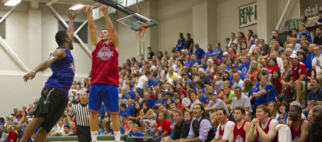 Tyrel Reed launches a three over Keith Langford during the Rock Chalk Roundball Classic held Thursday, June 14, 2012, at Free State High.