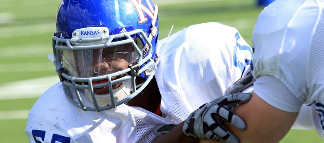 KU linebacker Michael Reynolds (55) works against a defensive lineman during practice on Tuesday, April 17, 2012, at the KU practice fields.