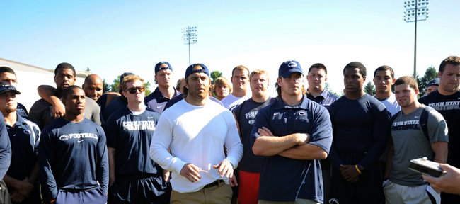 Penn State senior running back Michael Zordich, left foreground, and senior linebacker Michael Mauti, right foreground, give a statement in support of their team Wednesday, July 25, 2012, in State College, Pa.