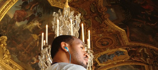 Kansas senior guard Travis Releford listens to a tour guide during a tour of the Palace of Versailles on Friday, Aug. 10, 2012, in Versailles, France.
