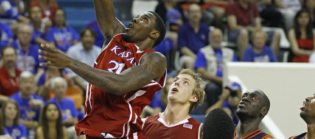 Kansas' Jamari Traylor scores as teammate Zach Peters looks on during an exhibition between KU and AMW Team France on Saturday, Aug. 11, 2012, at the Coubertin Stadium in Paris.