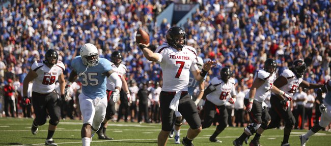 Texas Tech quarterback Seth Doege escapes Kansas defensive end Toben Opurum as he throws for a touchdown during the second quarter on Saturday, Oct. 1, 2011 at Kivisto Field.