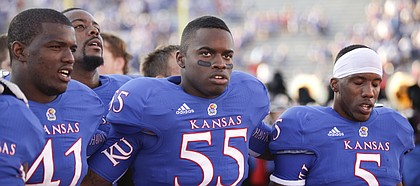 Kansas players Jimmay Mundine (41) Michael Reynolds (55) and Greg Brown (5) sing the Alma Mater to the student section following their 25-24 loss to Rice on Saturday, Sept. 8, 2012 at Memorial Stadium.