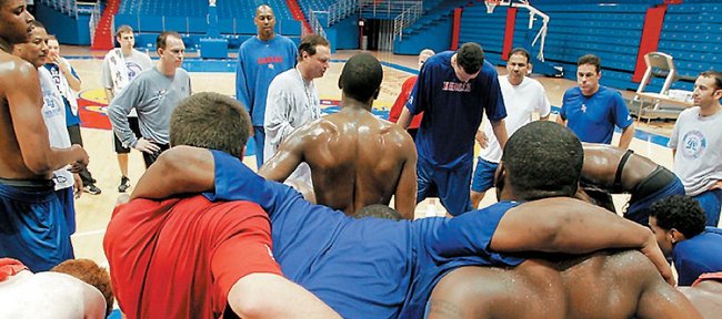 KU coach Bill Self huddles with the Jayhawks after a Boot Camp conditioning session in this file photo from 2006. 