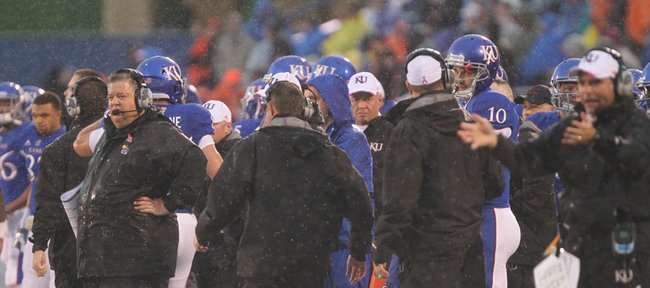 Kansas head coach Charlie Weis, left, watches after a fake field-goal attempt fell well short of a first down during the first quarter on Saturday, Oct. 13, 2012 at Memorial Stadium.