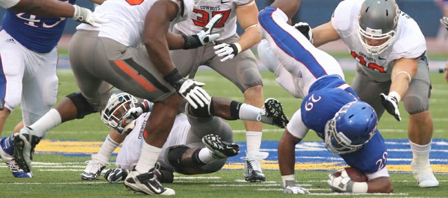 Kansas running back James Sims is upended by the Oklahoma State defense during the second quarter on Saturday, Oct. 13, 2012 at Memorial Stadium.