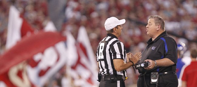 Kansas head coach Charlie Weis gives lip service to a game official as he disputes a call during the second quarter on Saturday, Oct. 20, 2012 at Memorial Stadium in Norman, Okla.