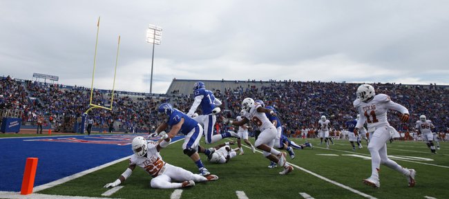 Kansas receiver Christian Matthews (12) gets a block from lineman Tanner Hawkinson (72) as he hurdles into the endzone against Texas during the second quarter on Saturday, Oct. 27, 2012 at Memorial Stadium.