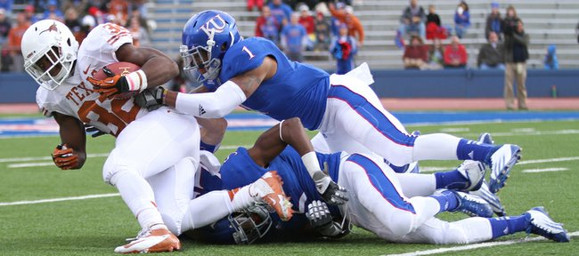 Kansas safety Lubbock Smith drags down Texas running back Johnathan Gray during the first quarter on Saturday, Oct. 27, 2012 at Memorial Stadium.
