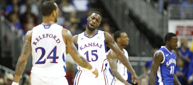 Kansas guard Elijah Johnson slaps hands with teammate Travis Releford after a breakaway bucket by Releford against Saint Louis in the first half of the championship game of the CBE Classic, Tuesday, Nov. 20, 2012 at the Sprint Center in Kansas City, Missouri.