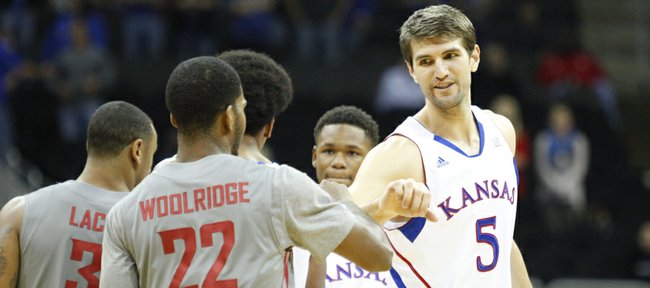Kansas center Jeff Withey fist bumps his former teammate Royce Woolridge before tipoff of the CBE Classic, Monday, Nov. 19, 2012 at the Sprint Center in Kansas City, Missouri.