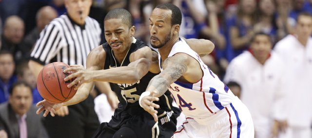 Kansas guard Travis Releford knocks the ball away from Colorado guard Spencer Dinwiddie during the first half on Saturday, Dec. 8, 2012 at Allen Fieldhouse.