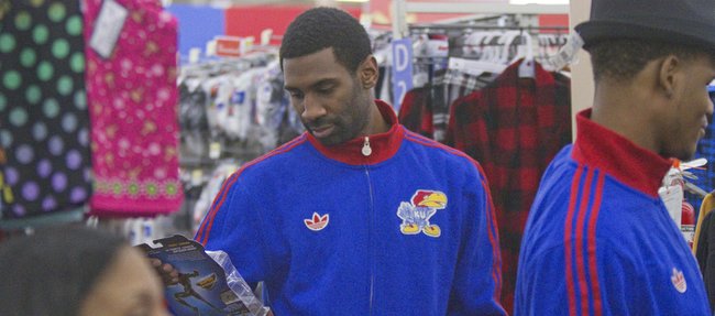 KU junior Justin Wesley sports a broken finger as he looks for gifts on Thursday, Dec. 13, 2012, during the Jayhawks' holiday shopping excursion to Wal-Mart.
