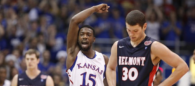 Kansas guard Elijah Johnson raises up the fieldhouse after an alley-oop dunk from center Jeff Withey against Belmont during the first half on Saturday, Dec. 15, 2012 at Allen Fieldhouse. In front is Belmont forward Trevor Noack.