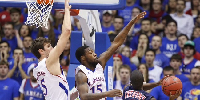 Kansas defenders Elijah Johnson (15) and Jeff Withey swoop in to defend against a shot by Richmond guard Kendall Anthony during the first half on Tuesday, Dec. 18, 2012 at Allen Fieldhouse.