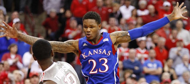 Kansas guard Ben McLemore extends all his limbs as he defends against an inbound pass from Ohio State forward Sam Thompson during the first half on Saturday, Dec. 22, 2012 at Schottenstein Center in Columbus, Ohio.