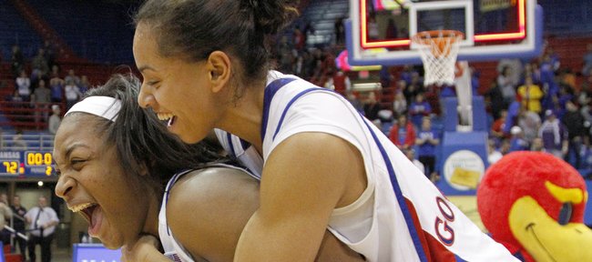 Angel Goodrich, top, jumps on the back of Bunny Williams after the Jayhawks' 72-63 victory over Kansas State in Allen Fieldhouse, Wednesday, Jan. 2, 2013.
